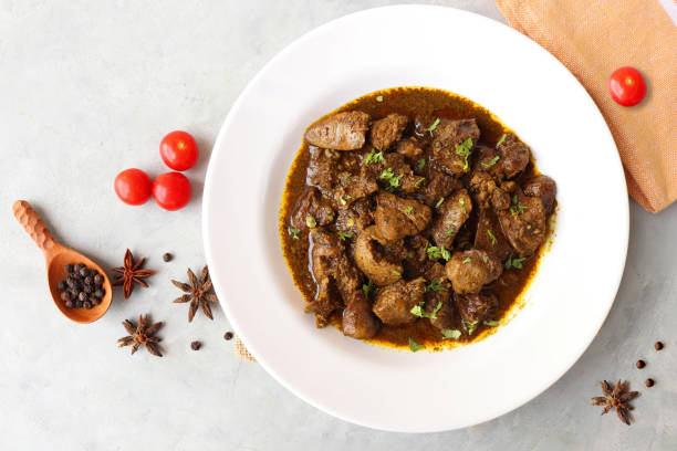 Chicken Liver Masala or Kaleji fry garnished with coriander. Liver fry is a very popular Nonvegetarian Indian dish. Made from the Chicken liver. White background. copy space with spices.