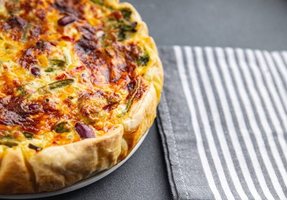 quiche vegetable open pie savory baked goods puff pastry, corn, green peas, beans, green beans, bell pepper healthy eating cooking appetizer meal food snack on the table copy space food background